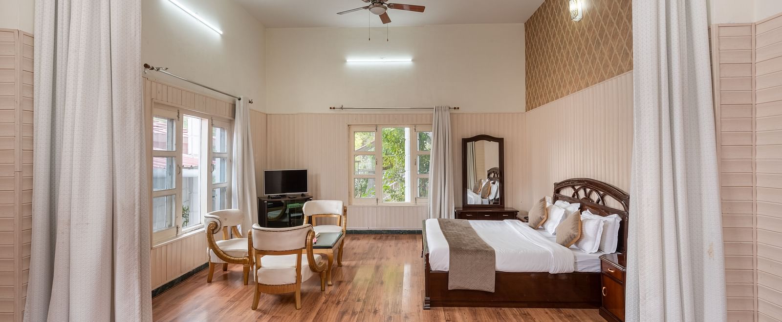 Luxurious suite featuring a bedroom and a living area at DLS Tehri Club Resort.